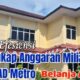 Tumpukan dokumen anggaran dan alat tulis kantor di meja kerja.